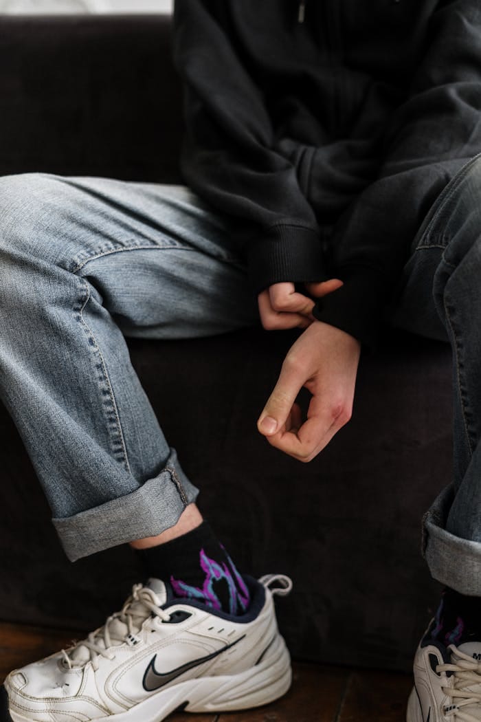 Person in Black Blazer and Blue Denim Jeans